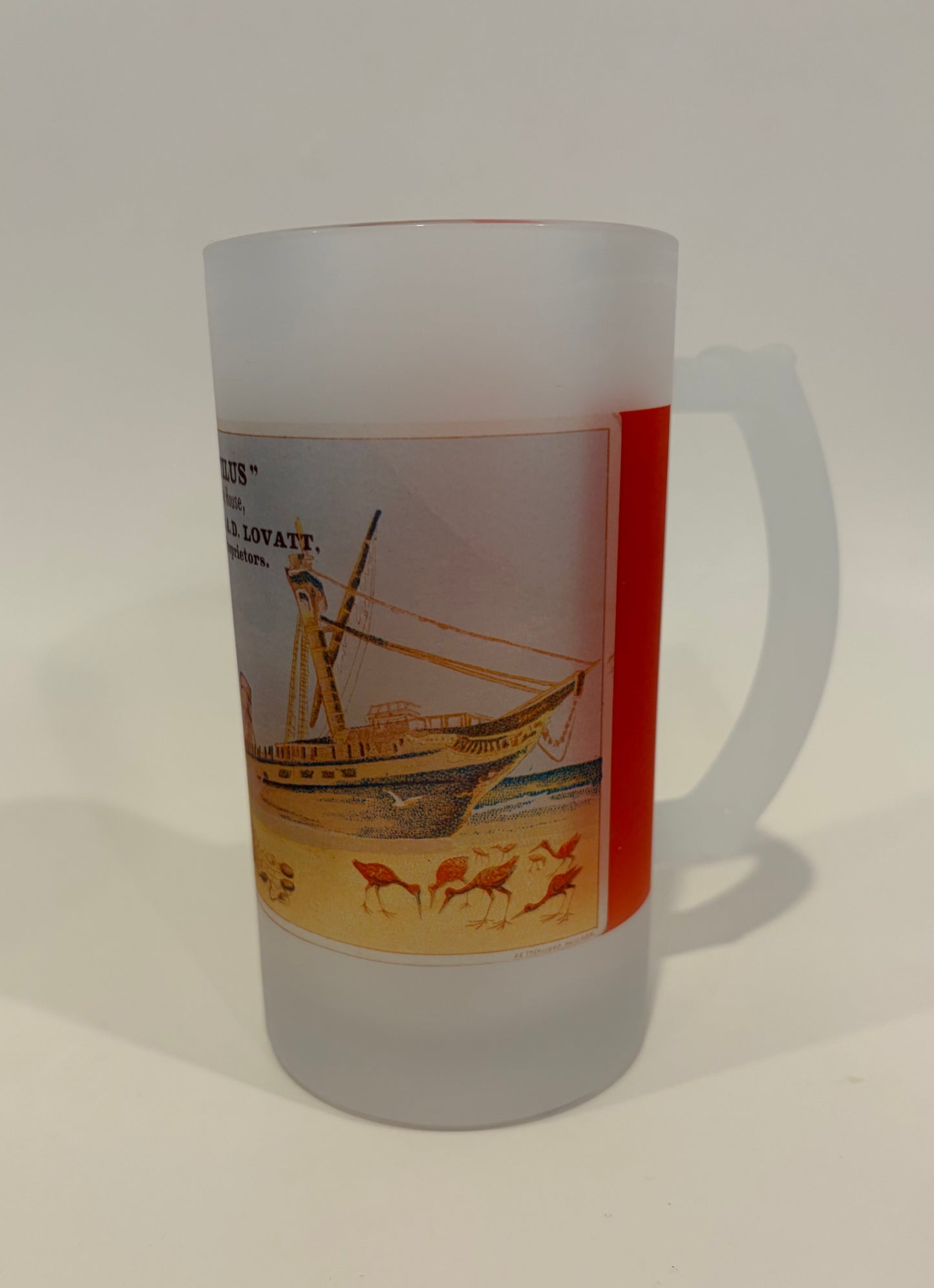 Cylindrical product with a label featuring a sailboat design on a white background