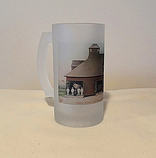 Frosted glass mug with a printed design of a building and people on a white background