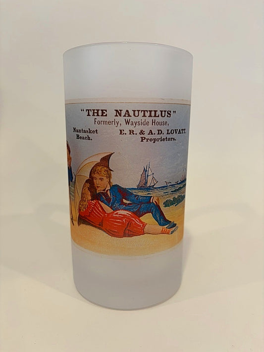 Frosted glass with vintage-style label featuring a beach scene and text.