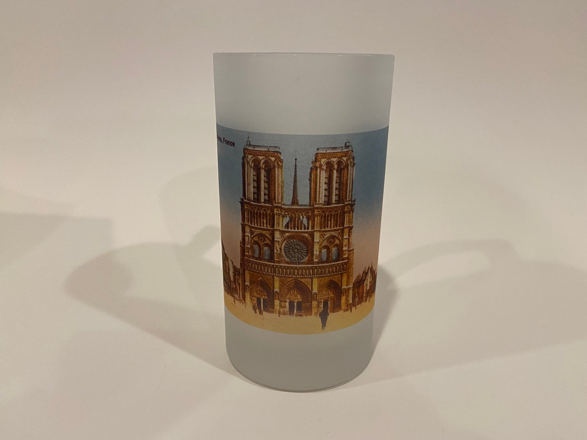 Frosted glass tumbler with a design of a famous landmark on a plain background