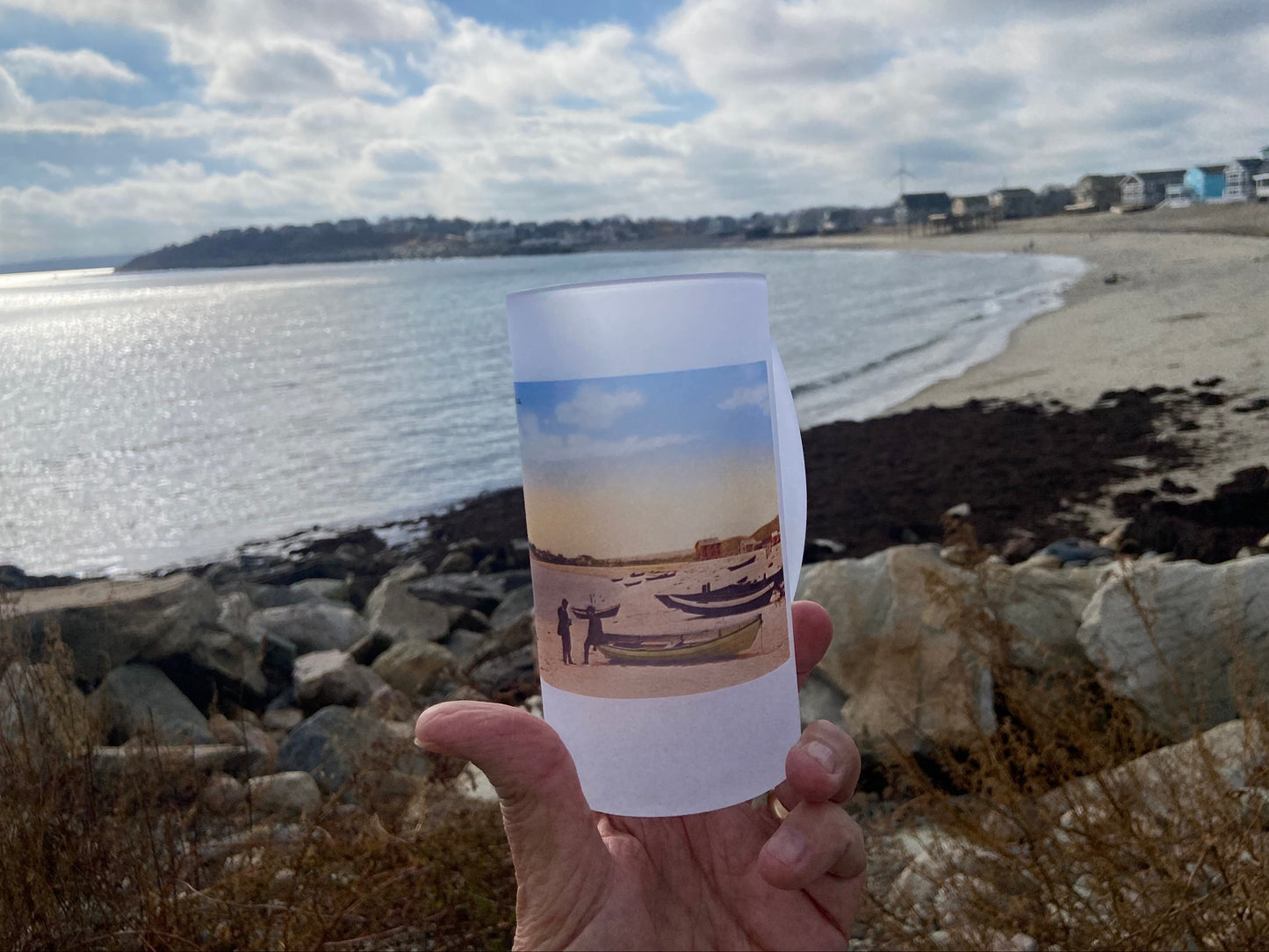 Beer Mug with antique beach photo on it in from of same beach 100 years later.