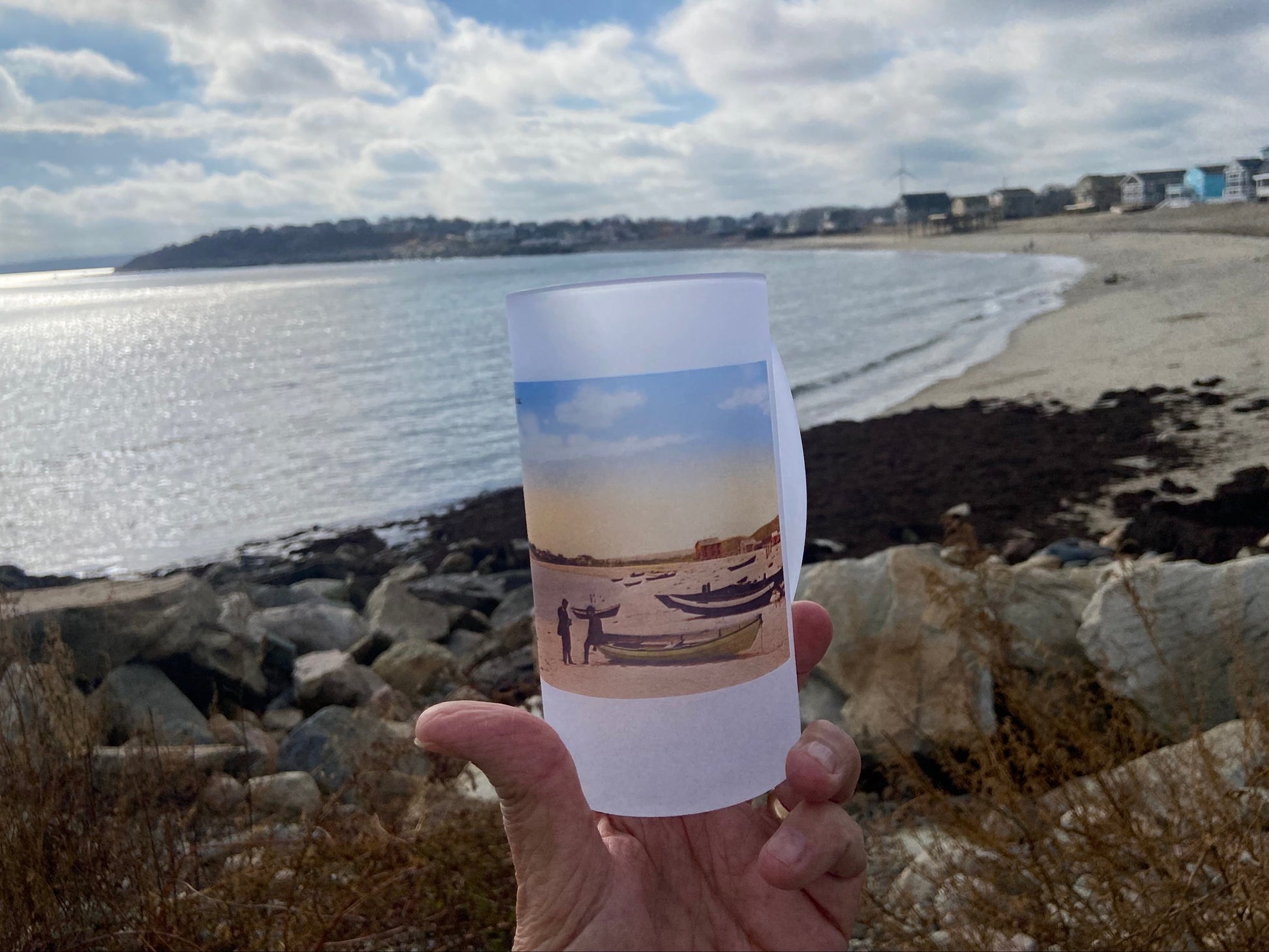 Beer Mug with antique beach photo on it in from of same beach 100 years later.