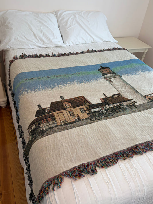 Bed with Blanket showing cape cod lighthouse